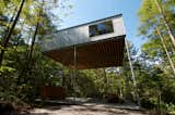 Nine slender, 100 x 100 millimeter square steel columns that are held in place by crossed braces on all four sides hold the small weekend house 6.5 meters in midair.