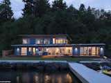 “The main level’s roof form echoes the previous home, while the upstairs roof is oriented to gather as much light and lake view as possible,” says project architect Kevin Witt, AIA. A Nu-Ray Metals standing seam roof in old town gray covers it all.  Kelly Dawson’s Saves from A Richly Detailed Seattle Home Built Around a Family's Active Lifestyle