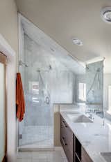Carrara marble was used in the shower and on the countertops. The fixtures are from Hansgrohe.