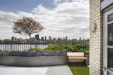 Since the building's facade is landmarked, the existing fence could not be altered. The architects responded by dressing up the perimeter with garden and design elements. Benches punctuate steel planters, creating a sitting area along the terrace walkway.