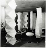 Isamu Noguchi, pictured here in 1960 with his Akari floor lamps.