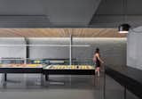 Thin, delicate LED lighting is suspended from the ceiling, giving the display cases sharp, focused illumination.  Photo 6 of 6 in A Modern Patisserie in Montreal