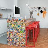 "We design mostly in black and white," Philippe Rossetti says of his work with Simon Pillard for Munchausen. But the duo are clearly unafraid to use color within their own home, outfitting their kitchen island—a simple wooden block—with 20,000 Lego pieces. Photo ©Céline Clanet.