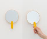 Sabi's wall-mounted detachable hand mirror ($50) magnifies two times and is encased in cheery yellow or neutral gray.