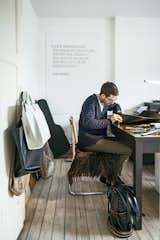 Office, Medium Hardwood Floor, Study Room Type, and Desk Verheyden works at his desk in the home office; over-flow projects are tackled in the workshop adjacent to the house, which is covered in black wood.  Search “workshop” from A Clever Belgian Couple Renovate Their Aging Brick Home