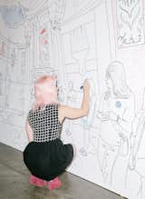 A visitor works on IdeaPaint’s dry-erase coloring wall.