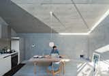 Tamotsu Nakada enlisted his friend, architect Koji Tsutsui to design his 793-square-foot home on an equally tiny lot. By chopping the downslope of the roof diagonally, Tsutsui made the interior of the so-called Bent House feel more expansive, and allowed sunlight to stream inside.