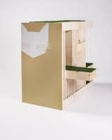 The Kitty Condo by RNL offers cats multiple turf-lined vantage points for surveying their surroundings, some of them partially obsucred by layared wooden slats.