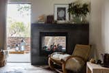 The double-sided fireplace is wrapped in a custom surround made fron Cor-Ten steel. The rocker is vintage and the artwork is from the Lost Art Salon.