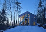 The home’s cubed shape keeps the footprint small, while the overhang was designed to accommodate the changing angle of the sun. It prevents overheating in summer while admitting as much winter sunlight as possible.  Search “how boxy would you go look modern box homes” from Dozens of Levels Give a Quebec Home Stadium-Sized Views of the Forest