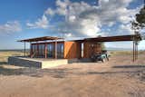 This prefab house in West Texas is comprised of two modules: one that houses the living area, and one that features the utility-and-laundry area, as well as the outdoor kitchen. Both modules were built in a factory in Utah before being delivered to the 30,000-acre ranch where they were installed by crane.