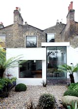 The rear of the house features Victorian brick, a modern extension, and Velfac windows. Landscape designer Matthew Wright was inspired by the art of Henri Rousseau when choosing plants to set amid the garden’s Dorset pebbles.