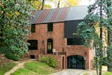 Exterior, Brick Siding Material, and Metal Roof Material In Arlington, Virginia, a drafty house was made more than twice as efficient with the addition of metal both inside and out. Roof panels topping the brick envelope echo its original geometry.  Photo 1 of 5 in Steel Preserve