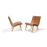 Shortly after his arrival to the United States in 1939, Risom met Hans Knoll, the founder of Knoll, with whom he would work to produce some of the company's earliest interior and furniture designs. Widely known as the first chair to be designed for Knoll, this iconic Risom Lounge Chair brought the natural materials and understated form of Scandinavian design to large-scale U.S. production. It makes use of few materials that were widely available during wartime—surplus army webbing and parachute straps—wrapped around a supple, curving wooden frame.