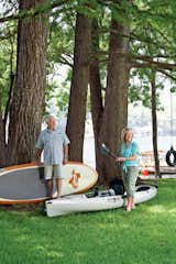 Owners Dudley and Sandy Youman keep a flotilla of watercraft ready for entertaining their children and grandchildren. Interior designer Herb Schoening worked with the Youmans on the furnishings and finishes for the their 480-square-foot-cabin.