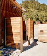 Outdoor and Back Yard Though the home includes a full bathroom, the Bairds primarily use the outdoor shower for bathing; the fixture is from Signature Hardware.  Photo 2 of 6 in dream home by reilly bowerman from Goodbye Grid and Cushy Beds, Hello Pool in the Wilderness