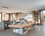 A massive slab of cypress perched atop sawhorses provides storage for pots and utensils.  Photo 5 of 18 in A Sonoma Prefab That Celebrates a Family’s Passion for Cooking