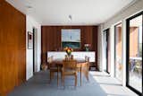 Dining Room, Ceramic Tile Floor, Table, Storage, and Pendant Lighting Mahogany paneling, original to the house, was reused as much as possible.  Photos from Not the Eichler Post-and-Beam Style You Know