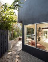 Outside, “they wanted the materials to feel a bit rustic,” landscape designer Michelle Frier says. To achieve that look, she selected gravel, pavers made from horizontally cut tree stumps, and reclaimed wood decking.  Photo 7 of 11 in Jenni Konner’s Hollywood Pad Is Ready for Its Close-Up