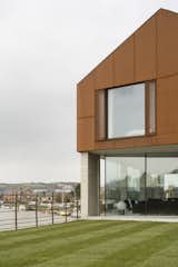 The upper story is clad in a decorative rainscreen of Cor-Ten steel mesh, chosen in part for its tone, which complements the red clay brick used locally.  Photo 6 of 7 in Bold House Doubles as a British Town's Welcome Sign