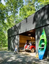 Garage The spacious detached garage stows a bevy of kayaks and inner tubes, not to mention the family car.   Photos from Three Joined Cabins Turn This Virginia Retreat Into a Modern Take on Camp