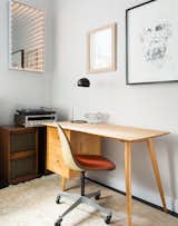 In the office, a 1950s desk by Paul McCobb is complemented by an Eames chair and the Boi desk lamp by David Weeks Studio. The lighted mirror is a piece called "Through the Looking Glass" by Earl Reiback.