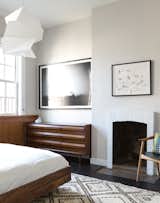 Bedroom and Bed The chair, by Danish designer Arne Hovmand-Olsen, was purchased through Wright. The dresser was sourced from Chairish.  Photo 7 of 7 in 725 Square Feet and Loads of Modern Gems