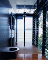 Bath Room, Medium Hardwood Floor, and Open Shower Even the master bath is open to the surrounding water.  Photos from Three Glass-and-Copper Pavilions Conquer the Cliffs