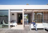 Exterior, House Building Type, and Flat RoofLine Tracy and Thaddeus enjoy an afternoon read from the master bedroom and terrace, respectively; the outdoor sectional is by Gandia Blasco.  Photo 5 of 10 in Amid a Hotbed of Architecture, This Home Holds Its Own