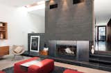 A slight gap between the existing house and the new addition allows for a skylight and a masonry chimney with a wood-burning fireplace.