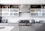 Charred House kitchen with quartz countertops and white open cabinets