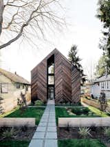 Passive House wood exterior with grass lawn.