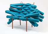 <b>Noelle Antignano, Rhode Island School of Design </b>
 Long tubular cushions are woven through a steel-rod frame to create this lounge chair that embodies the beauty of controlled chaos.