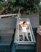 Kristine climbs out onto the concrete-tile roof deck through a hatch door in the upstairs loft.