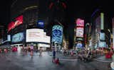 The contrast between Stanton's visual vocabulary and Times Square helps create the effect of viewing another world through a window. The Nasdaq screen stands out in particular since it wraps around the whole building.&nbsp;