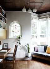 The original coffered wood ceiling of Kate Tucker and Tom Crago’s home in Melbourne, Australia, provides a dramatic backdrop for a vintage pendant from Angelucci 20th Century. “The bay windows and high ceilings were so lovely, we really wanted to do as little as possible up front,” Kate says of the plan for the house.