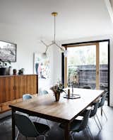 A Y chandelier by Douglas and Bec hangs above a vintage table and chairs.