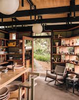 The ceramics studio was formerly a pergola wrapped in chicken wire, used as a dog kennel by the previous owner. Inside the new structure, a vintage Danish chair, found on eBay, provides a modern perch. The windows’ deep mullions double as display shelves.