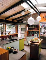 "Maintaining sight lines to the outdoors and the adjacent den, we introduced a connectivity that transforms the kitchen into the center of family life,