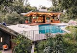 Rising from the edge of the pool deck, a planted overhang shelters a gym and sauna below.  Photo 3 of 4 in Editor’s Letter: Make It Modern