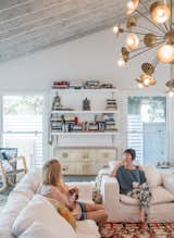 Actress Lena Headey (with her mother, Susan) worked with builder Ted Broden to give her 1950s house an open feel. The living room includes a Cloud Track Arm sofa and chair from Restoration Hardware, a Woven Accents rug, and a Keegan chandelier by Arteriors.