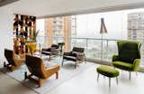 In an apartment overlooking São Paulo’s Ibirapuera Park—completed in 1954 to commemorate the city’s 400th anniversary—the furniture is as distinctive as the view. Architect Flavio Castro of FCstudio worked closely with the residents to update and outfit the home, which is appointed with a mix of contemporary and Brazilian modern classics. A pair of Sérgio Rodrigues’s Paraty armchairs (in foreground)—designed for Brasilia’s Itamaraty Palace in 1963—face a duo of Jader Almeida’s Isa armchairs in the living area. The green Ro lounge and ottoman are by Jaime Hayon for Fritz Hansen.