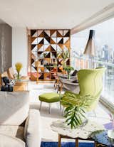 FCstudio updated the 5,000-square-foot apartment by removing several walls in central areas to clarify views and simplify the overall floor plan. The firm also custom-designed the Brazilian walnut room divider with a striking geometric pattern that allows light to traverse throughout the living area.