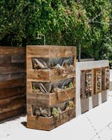 The outdoor shower, which he designed in collaboration with landscape contractors Warren-Avard, is surrounded by reclaimed hemlock planters.