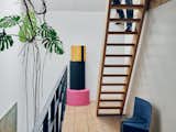 Staircase and Wood Tread A stack of foam poufs from Venlet’s colorful, candy-inspired Let’s Drop collection joins his blue, powder-coated Cake chair on the third-floor landing.  Photo 2 of 11 in Futuristic Forms Meet Historical Details in Designer Danny Venlet's Brussels Home