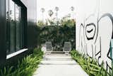A giant mural by the artist Daniel Johnston dominates the outdoor garden of an art-filled home in Venice designed by Chris Rudin.