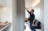 Graham Hill, a sustainability advocate whose TED talks have delved into the benefits of living small, put his own lessons into practice at his 350-square-foot apartment, which he shares with his partner and two dogs. Quick transitions, like drawing the FilzFelt curtain, convert the living space into a bedroom.