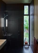 Bath Room, Open Shower, Wall Lighting, and Drop In Sink The shower is lined in Magma Black tile purchased at the Tile Space in Auckland.  Photos from A Tiny Footprint Isn’t So Bad When You Live in a Tower