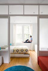 By replacing a wall with a custom wood-and-glass partition, architect Matt Krajewski transformed a previously dark one-bedroom railroad apartment in Manhattan into a light-filled home. Compact furnishings, like a Mandal bed frame from IKEA with integrated storage, maximize every inch of the 390-square-foot unit, housed in a former tenement building.