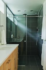 All three bathrooms feature Kohler fixtures, Caesarstone countertops, and slate ceramic tiles.